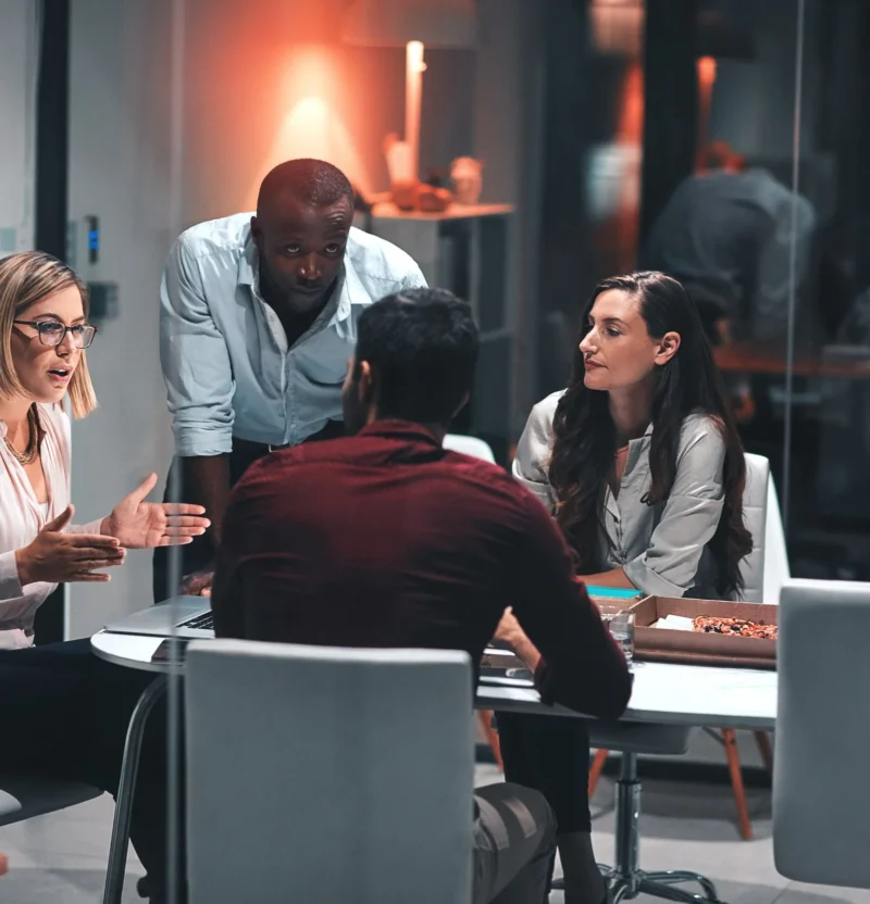 Colleagues talking around a meeting table